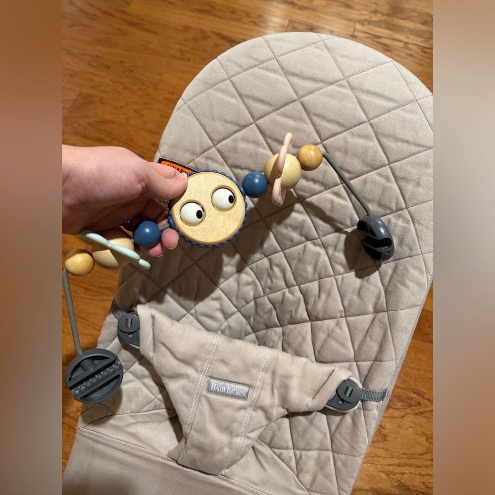 Beige baby Bjorn bouncer with Activity Bar